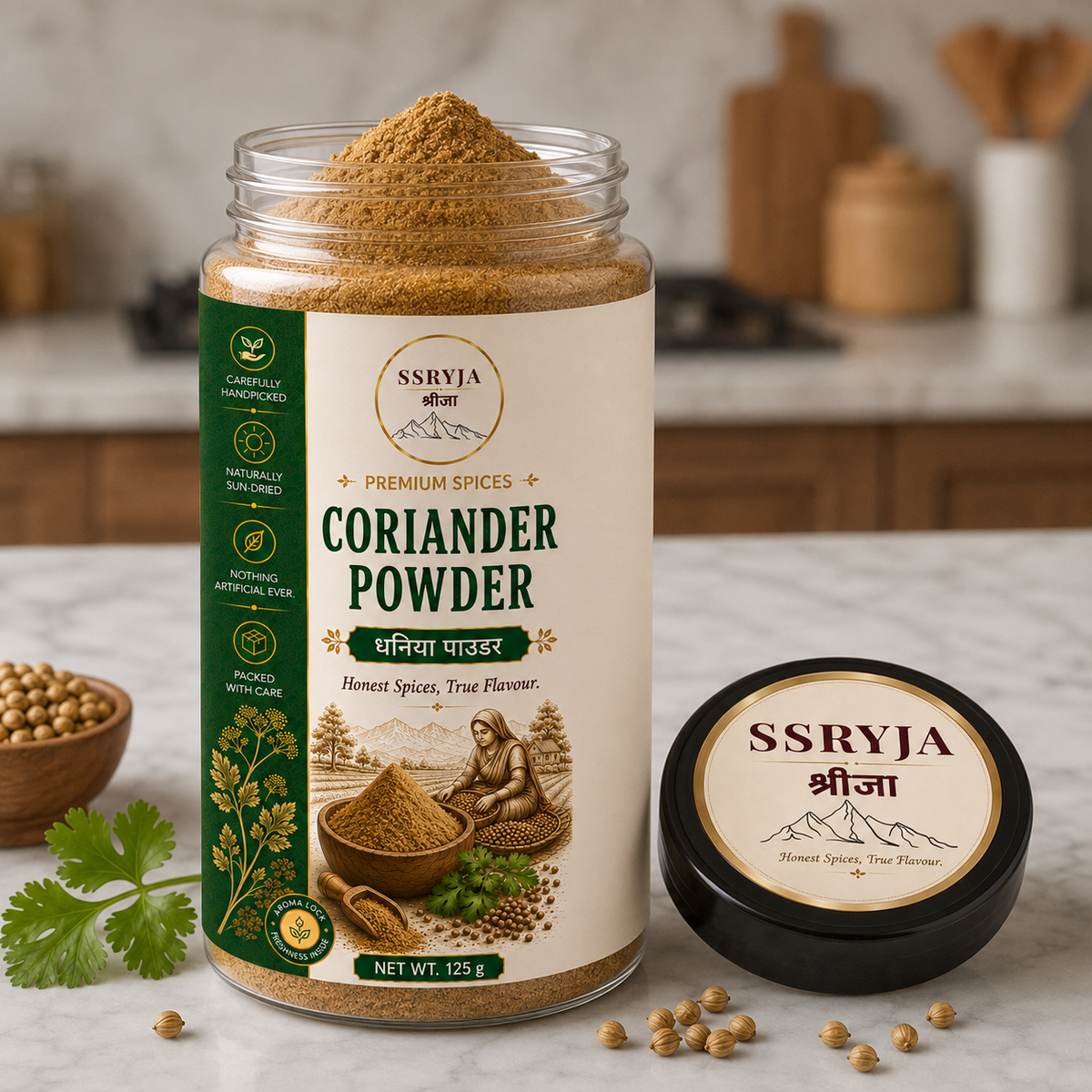 A jar of SSRYJA Coriander Powder with its lid placed beside it on a kitchen countertop, surrounded by coriander seeds and a sprig of cilantro. The background shows a softly blurred kitchen setting.