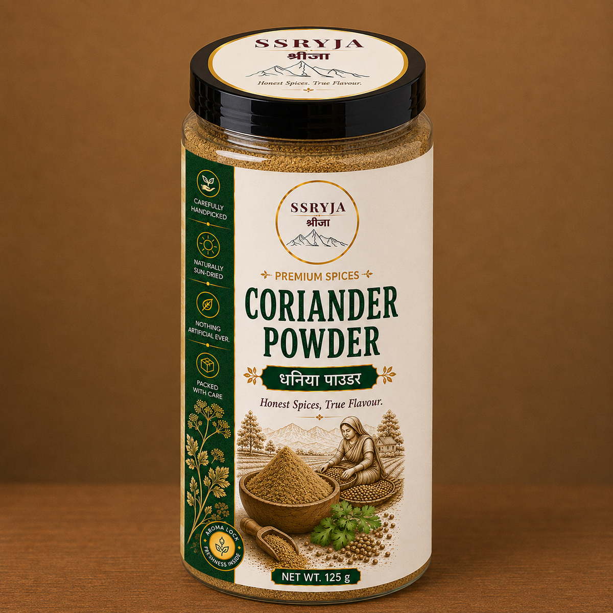 A jar of SSRYJA Coriander Powder on a wooden surface with a brown background. The jar has a black lid, a cream-colored label with green and gold text, and illustrations of coriander plants and seeds.
