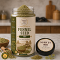 A jar of SSRJYA Fennel Seed spices with a cream and olive green label, shown alongside the black lid and loose fennel seeds on a kitchen counter.